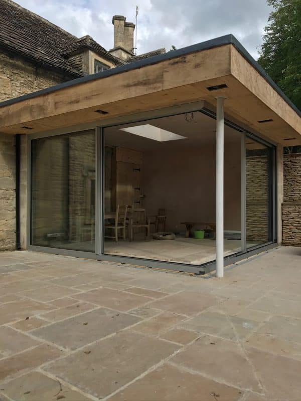 Open Corner Solarlux Cero II sliding doors installed in this completed garden room. 3 wood clad extension