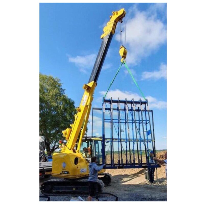 crane carrying a wide glazing piece