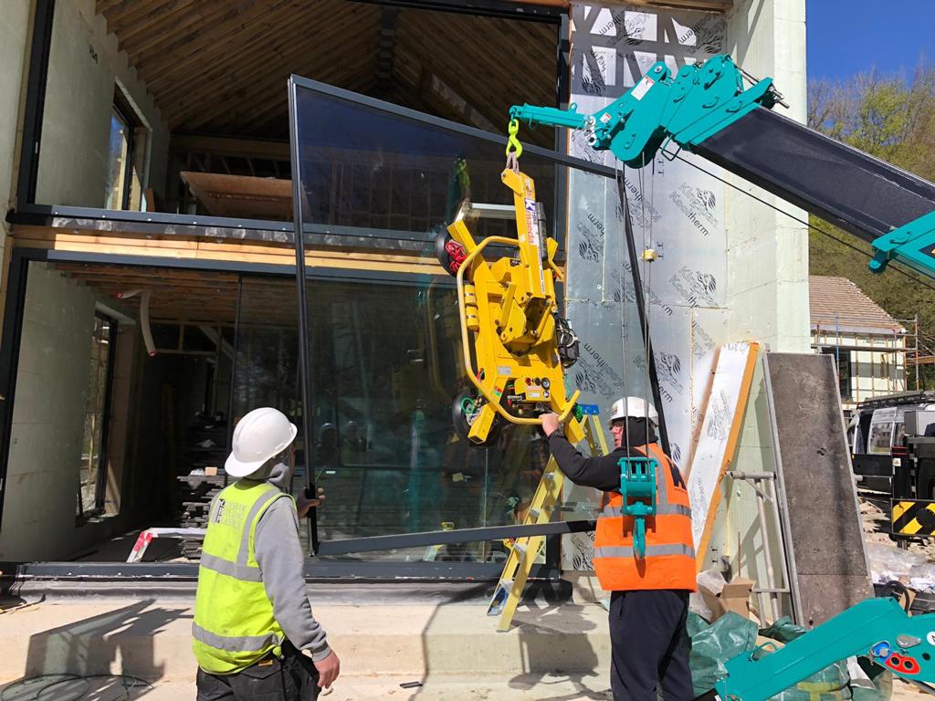 two men aligned crane and mirror for perfect lift